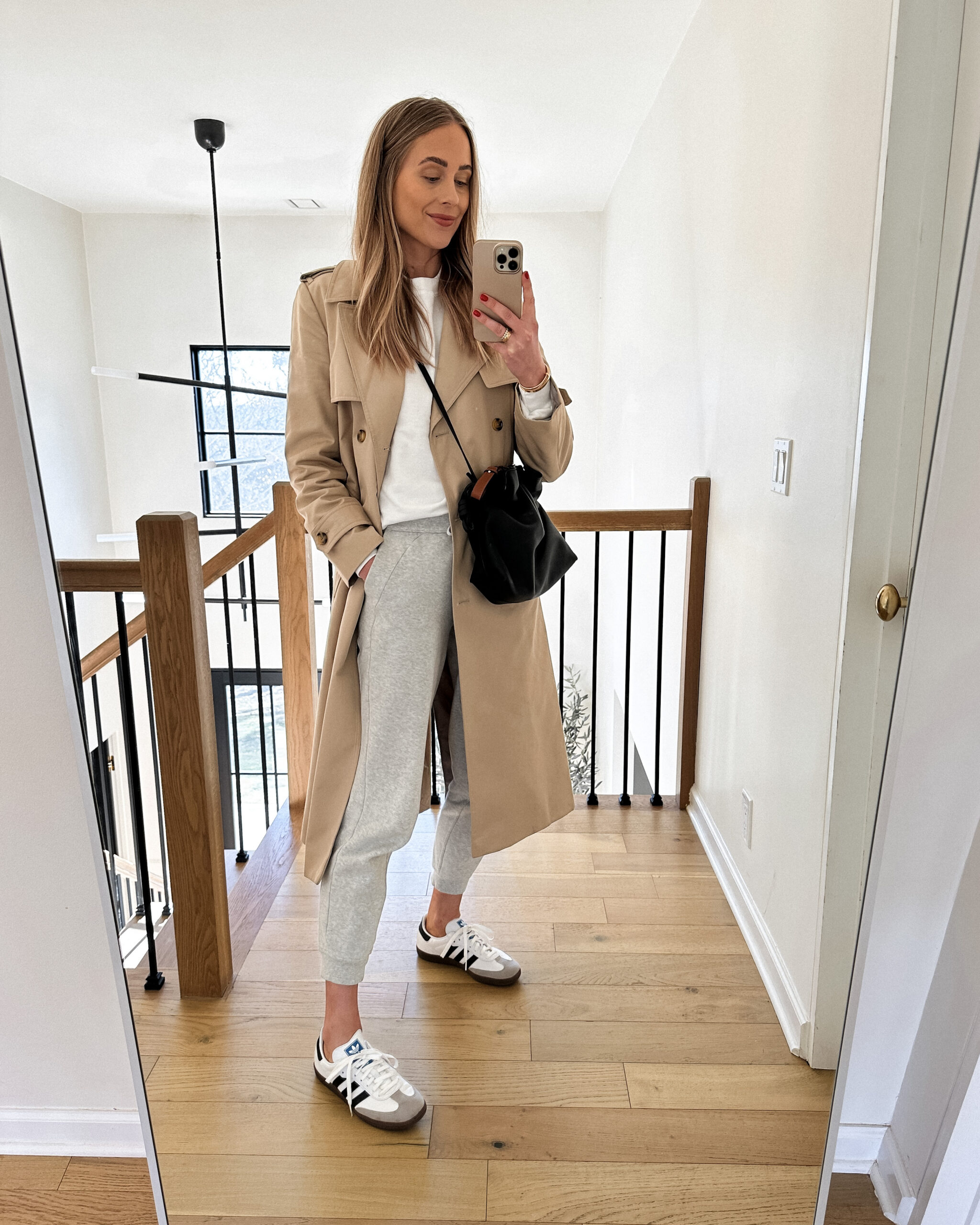 Fashion Jackson Wearing Mango Long Trench Coat White Sweatshirt lululemon Grey Joggers adidas OG Samba Sneakers White Loewe Flamenco Black Handbag Weekend Outfit Athleisure Outfit Casual Outfit