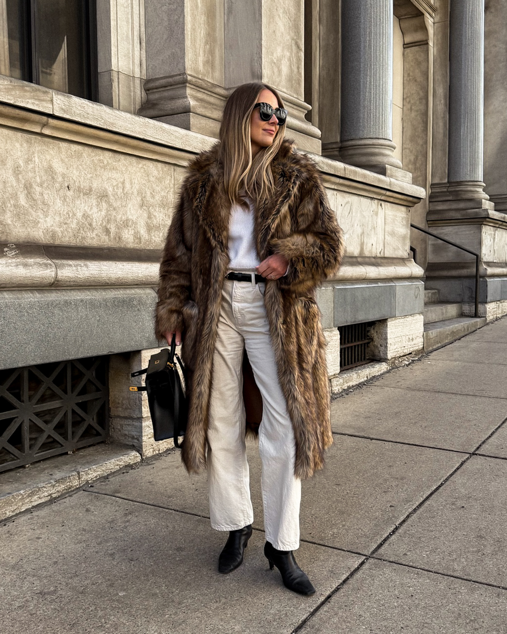 Fashion Jackson faux fur winter jacket white sweater white jeans black boots hermes kelly 32 box sellier black street style