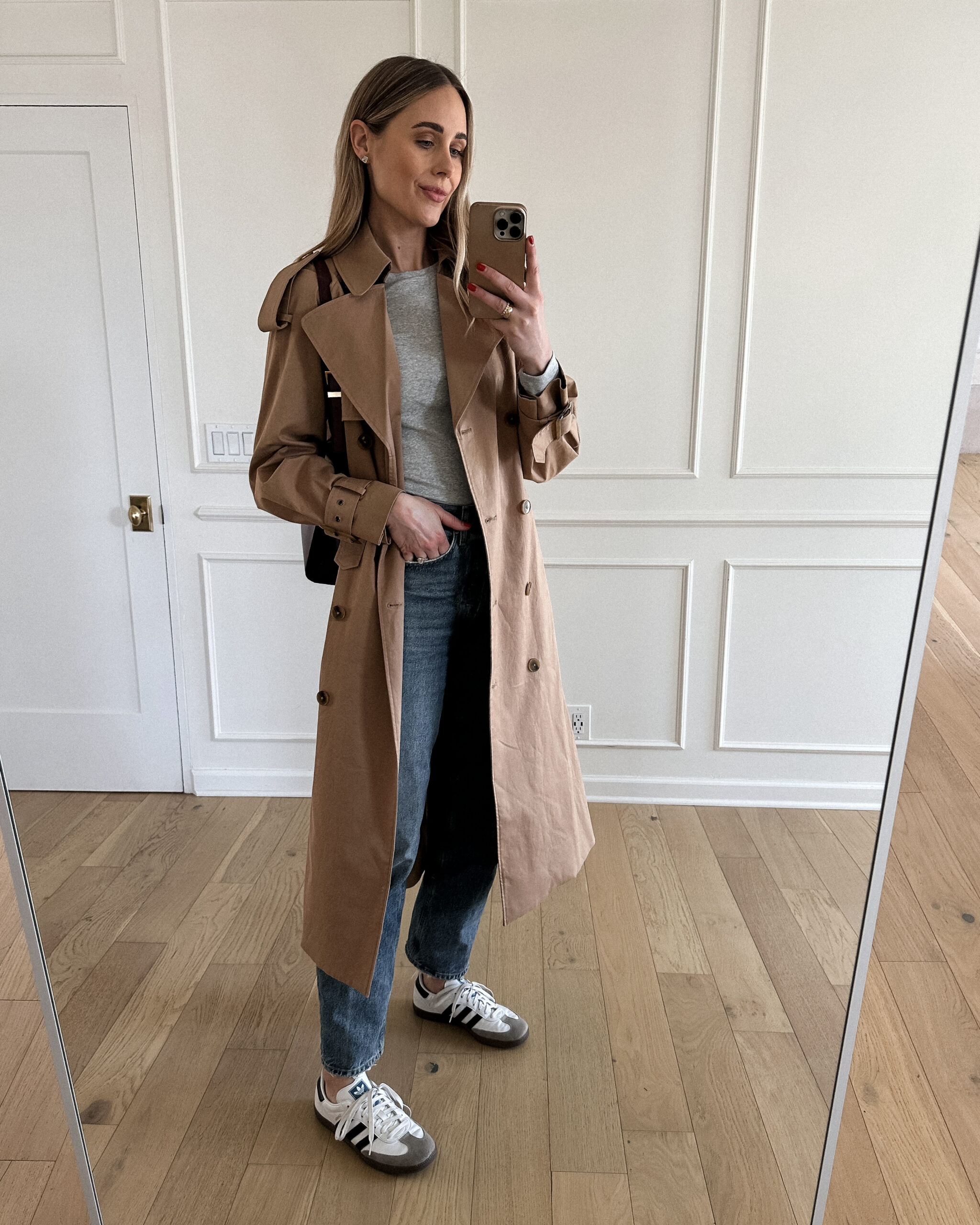 Fashion Jackson Wearing Mayson the label long trench coat, grey long sleeve tee, agolde denim jeans, adidas samba sneakers