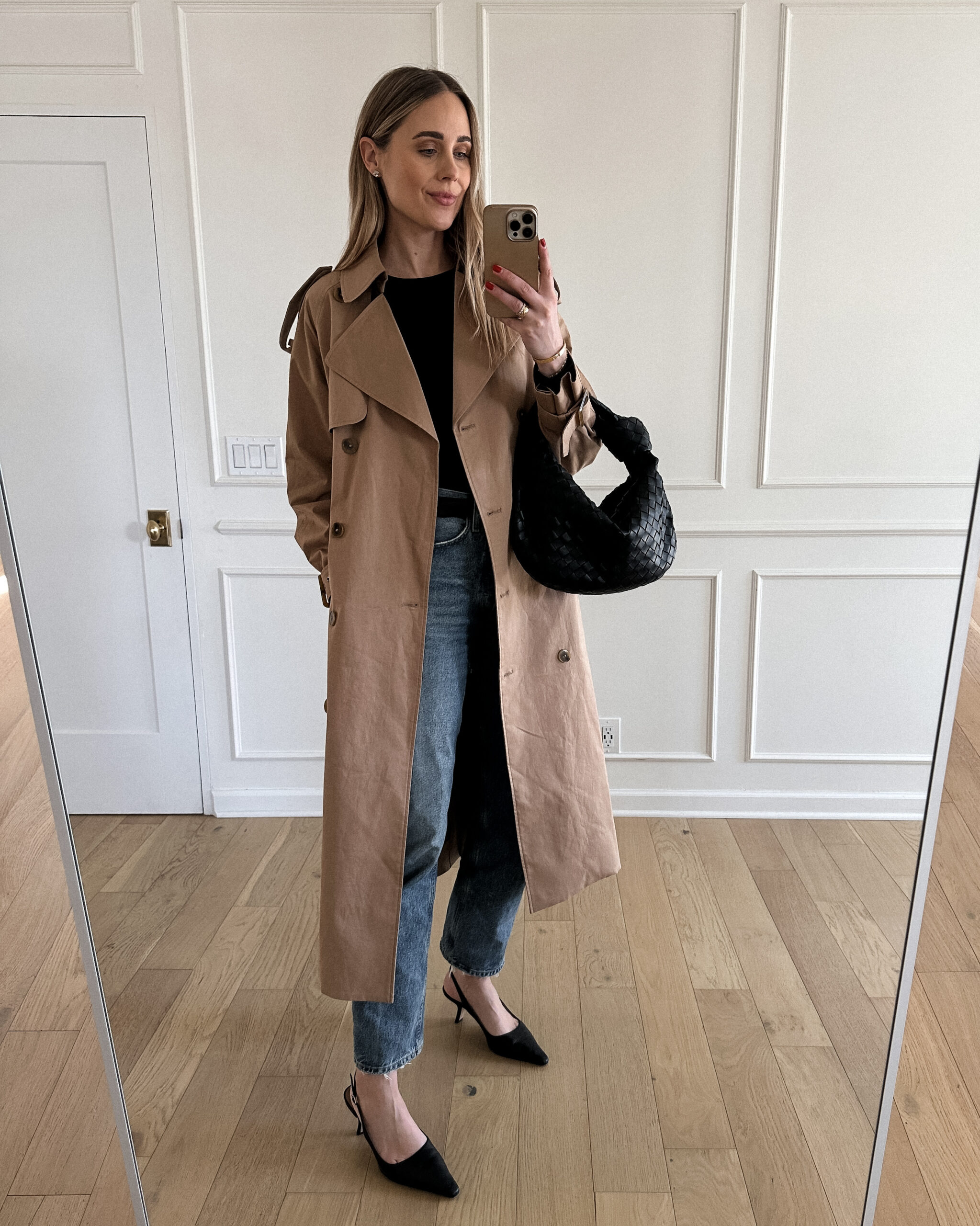 Fashion Jackson Wearing Mayson the label long trench coat, black long sleeve tee, agolde denim jeans, black slingbacks, bottega veneta teen jodie black
